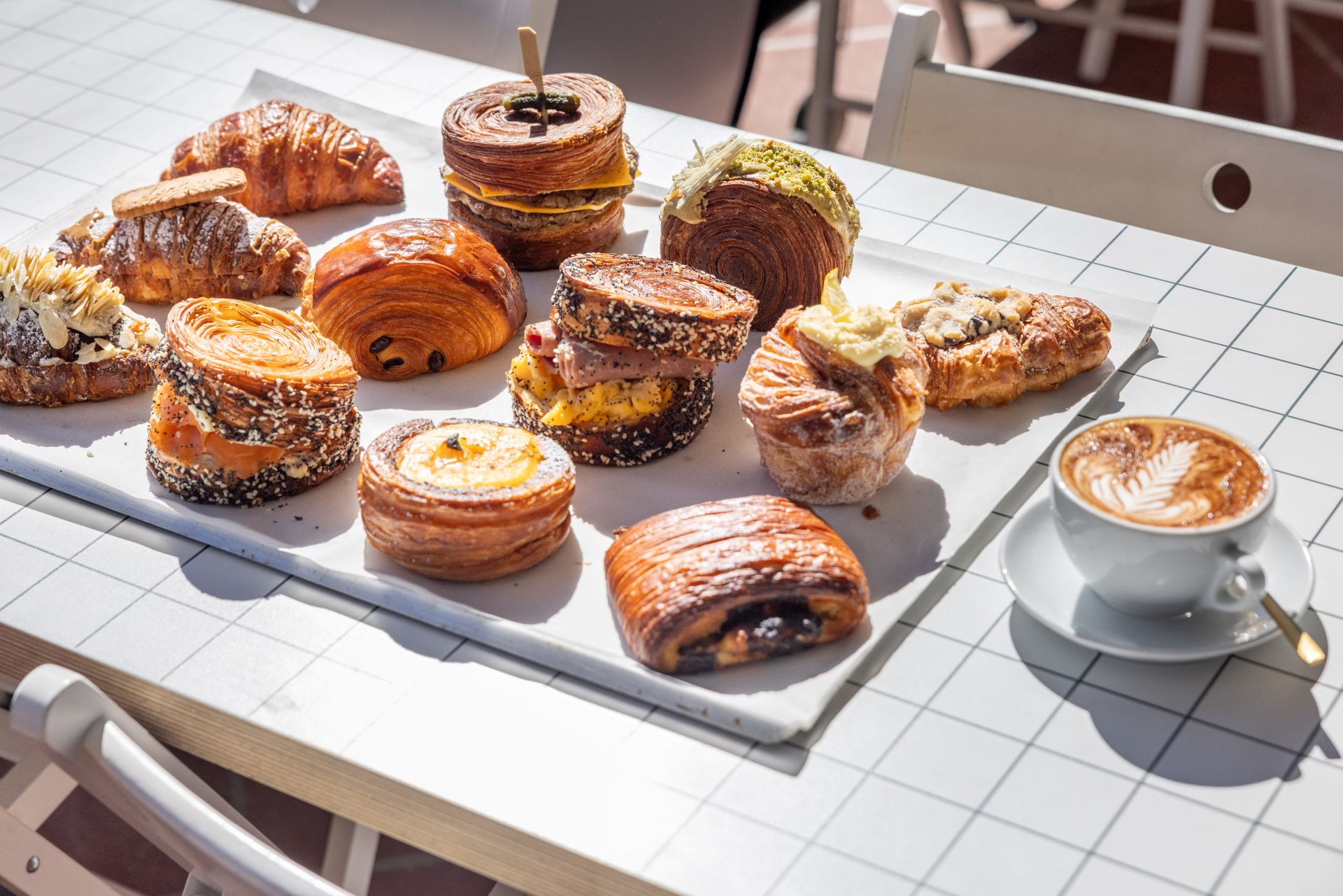 a tray of croissants with a mug of coffee