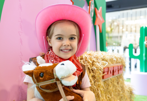 little girl wearing cowgirl costume