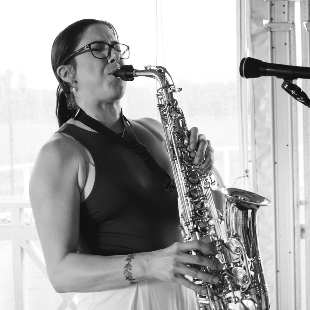 Maddie Collins playing saxophone on stage